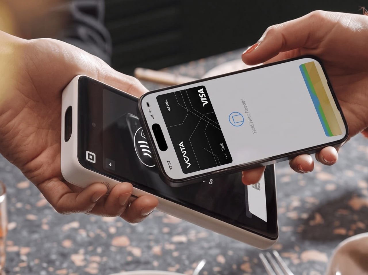 Paying with VantaCard through Apple Pay by tapping an iPhone on a card reader